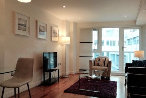 Modern living room with large windows and contemporary furniture.