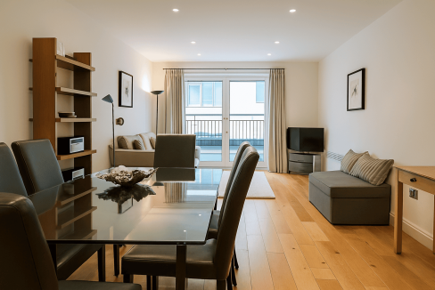 Spacious living room with balcony, contemporary furniture, and natural light in Tower Hill.