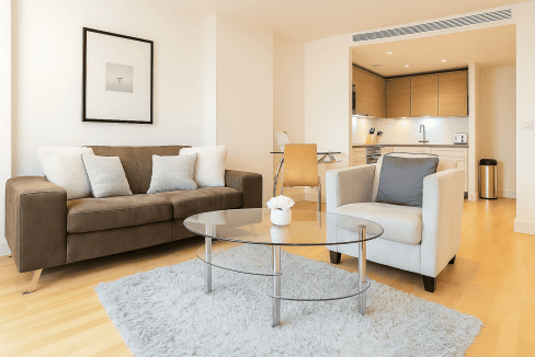Vauxhall Manhattan one-bedroom apartment living room with contemporary furniture and open-plan kitch.