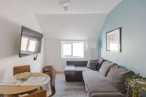 Cozy living room in Fitzrovia Grafton Mews St Apartments with modern decor and natural light.