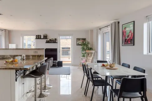 Modern apartment living room with dining area and kitchen.