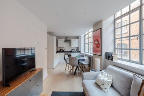 Farringdon Eyre St Hill Apartments living room with large windows and modern furnishings.
