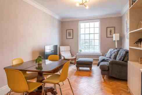 Cozy living room in Marylebone Devonshire Street Apartments, featuring a comfortable sofa, armchair,.