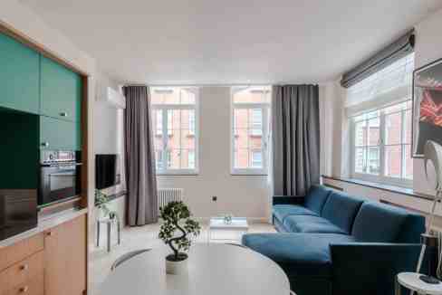 Modern Soho Brewer Street Apartments living room with stylish furniture and large windows.