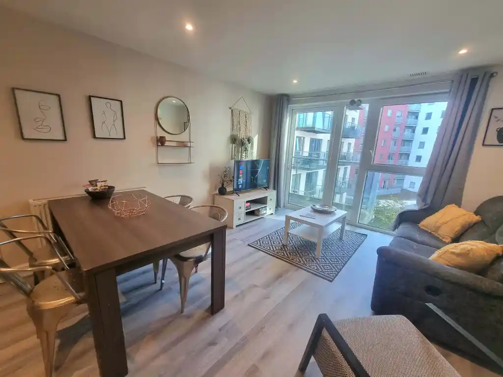 Bright living room with large windows and modern decor.