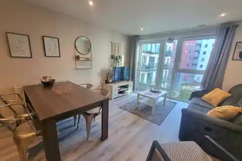 Bright living room with large windows and modern decor.