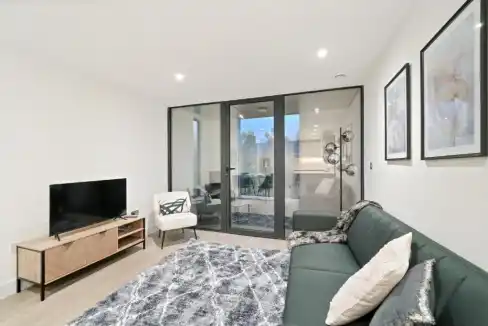 Stylish Camden Town Bayham Street apartment living room with modern furniture and large glass doors.