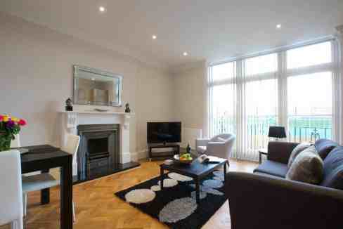 Modern living room with large windows and stylish furniture.
