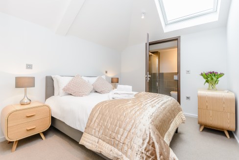 Bright bedroom at Richmond Worple Way Apartments featuring a skylight, neutral tones, and contempora.