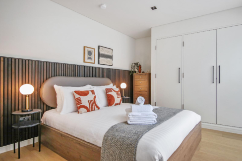 Stylish bedroom featuring a comfortable bed with decorative pillows and contemporary decor.