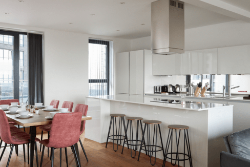 Contemporary open-plan kitchen and dining area in Canning Town serviced apartment.