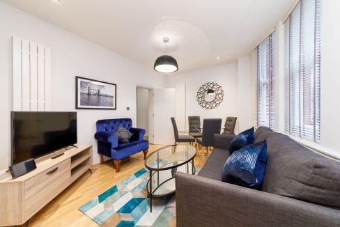 Bright and spacious living room with contemporary furniture and large windows in Charing Cross Road.