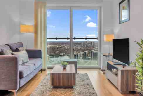 Cityscape view from a stylish living room overlooking Canary Wharf skyline.