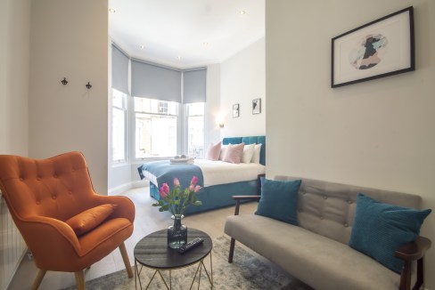 Elegant living space with modern furnishings in High Street Kensington Apartments.