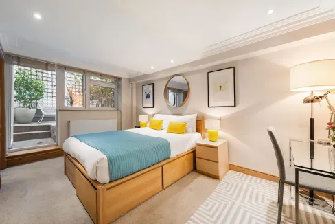 Bright bedroom in Marylebone with contemporary furnishings and large windows.