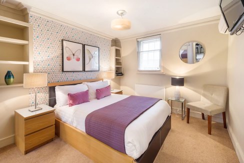 Bright bedroom in Marylebone with stylish decor, comfortable bed, and natural light.
