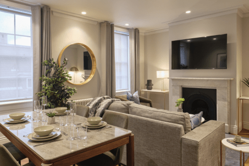 Bright and spacious living room with contemporary decor and large windows at Mayfair Darley House Ap.