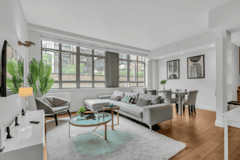 Bright and spacious living room in Clerkenwell City Road Apartments with modern decor and large wind.
