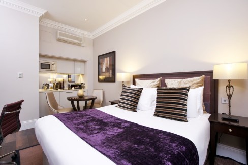 Comfortable hotel room with modern decor and cozy bedding.