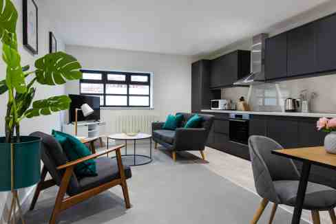 Queen's Park Serviced Apartments with contemporary living space and sleek kitchen design.