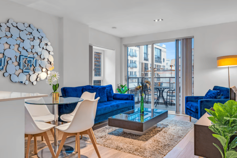 Bright and stylish living room in Shoreditch High Street Apartments with contemporary decor and larg.