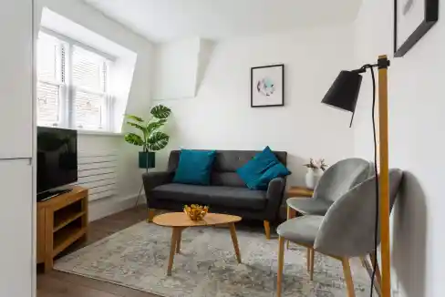 Victoria Serviced Apartments living room with modern furniture and natural light.