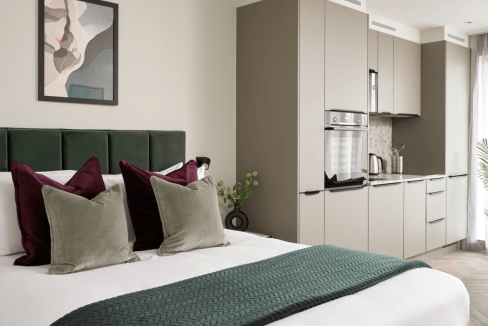 Stylish bedroom with modern decor in Whitechapel Apartments, London.