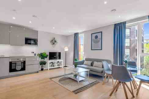 Bright, stylish living space with contemporary furniture and large windows in Elephant & Castle serv.
