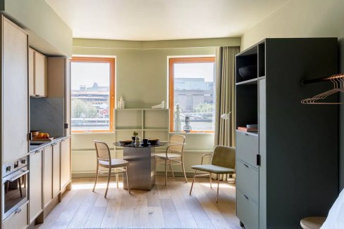 Bright living space with large windows overlooking London skyline and Millennium Bridge.