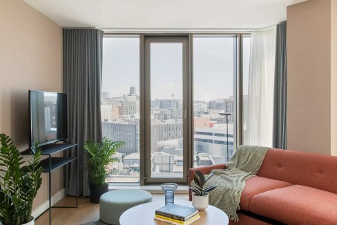 Modern living room in Liverpool Paradise Street Apartments with city views.