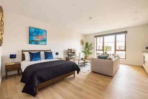 Spacious bedroom in Greenford Serviced Apartments with contemporary furnishings and natural light.