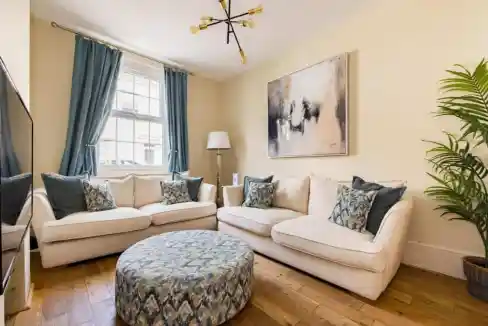 Comfortable living room featuring plush sofas, decorative pillows, and contemporary artwork in Salis.