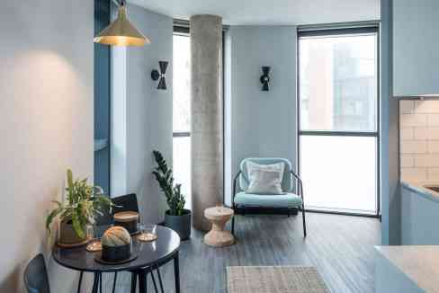 Modern Canary Wharf Aparthotel living room with stylish decor and large windows.