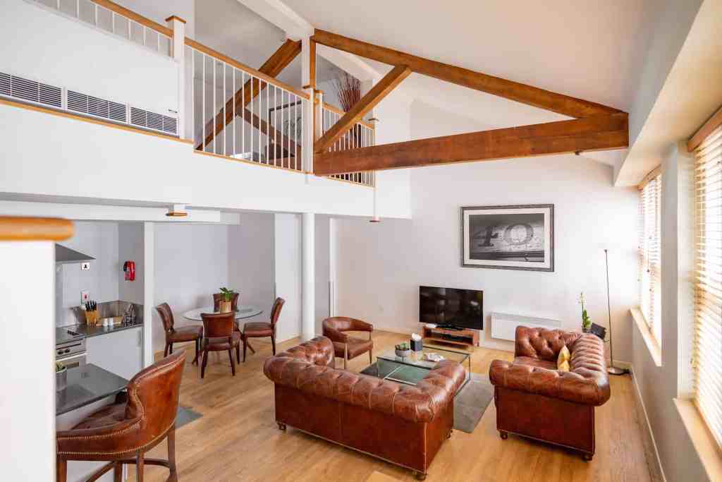 Liverpool Street Bishopsgate apartments living room with contemporary furniture and wooden accents.