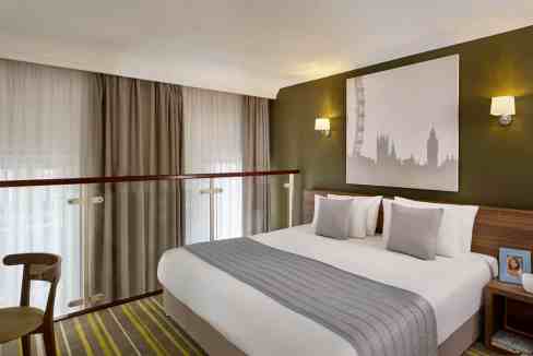 Comfortable hotel room with modern decor at South Kensington Aparthotel, London.