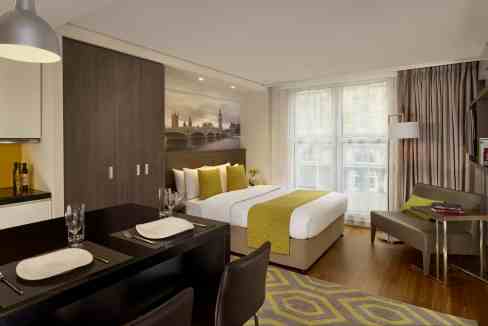 Comfortable hotel suite featuring contemporary furnishings and scenic London skyline views.