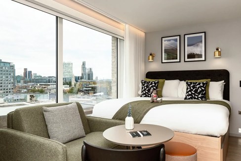 A spacious, contemporary apartment with large windows offering panoramic city views in Whitechapel,.
