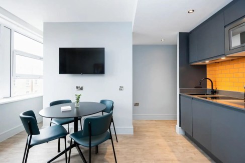 Modern apartment interior with dining area and kitchen in London Greenwich.