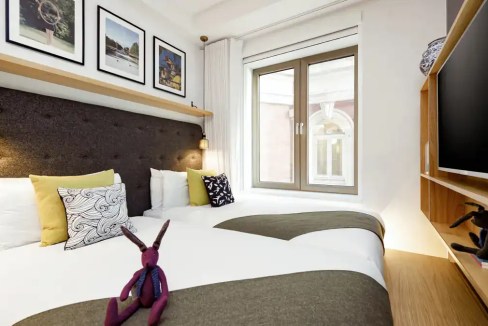 Modern bedroom at Covent Garden Adam Street Aparthotel with stylish decor.