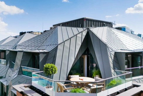 Rooftop terrace of Liverpool Street Aparthotel with outdoor seating and city views.