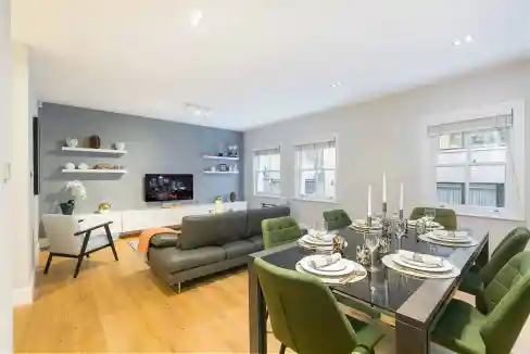 Marylebone Kenrick Place Apartments living room featuring contemporary furniture and bright windows.