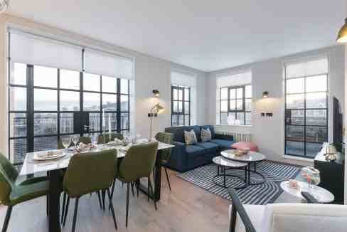 Luxury apartment living room with large windows and city views.
