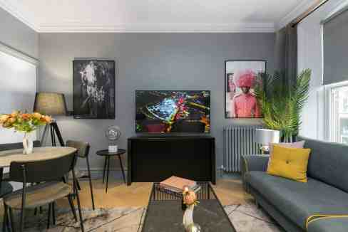 Stylish living room in Covent Garden serviced apartment with contemporary decor and natural light.
