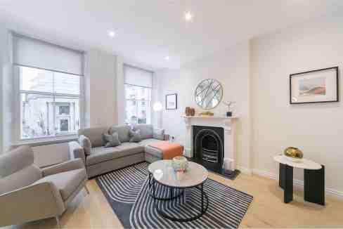 Bright living room in Covent Garden with stylish furniture and large windows.