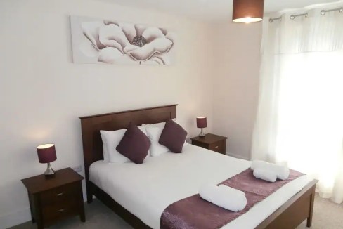Elegant bedroom with modern decor and cozy ambiance.
