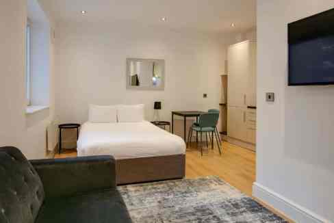 Bright, contemporary bedroom with comfortable bed and minimalist decor in Swindon central location.