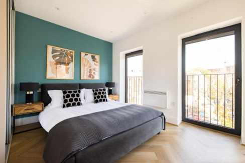 Modern bedroom with balcony overlooking Staines town.