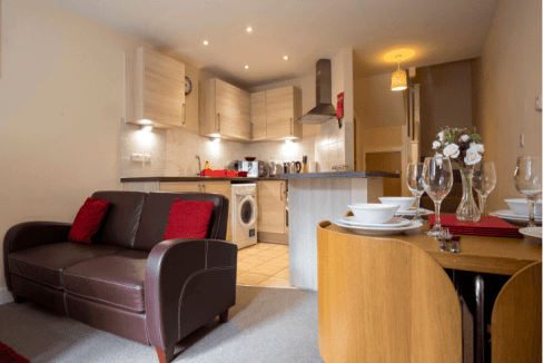 Cozy living area in Frimley Park serviced apartments with open-plan kitchen and dining space.