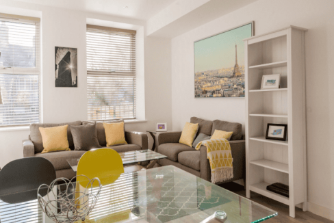 Modern living room at Guildford Bury Fields Apartments with comfortable sofas and stylish decor.