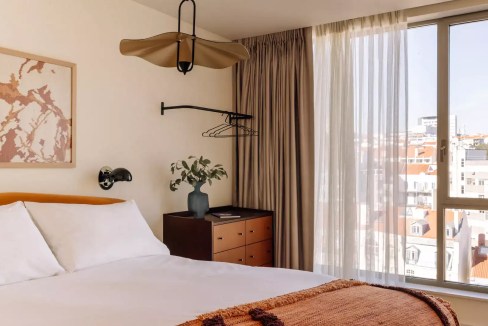Modern hotel room at Lisbon Liberdade Aparthotel with city views.